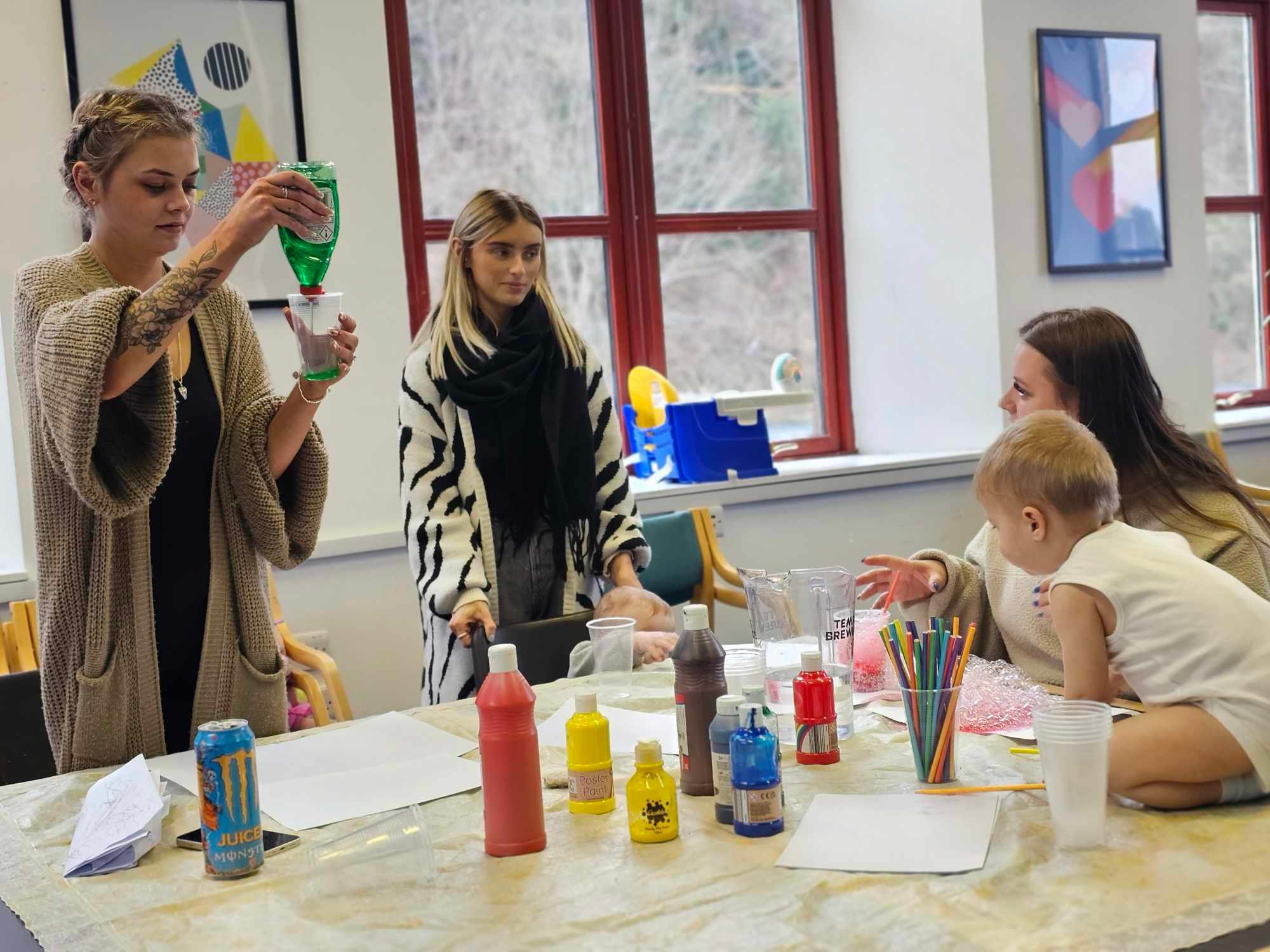Adults and young children enjoying a creative activity together