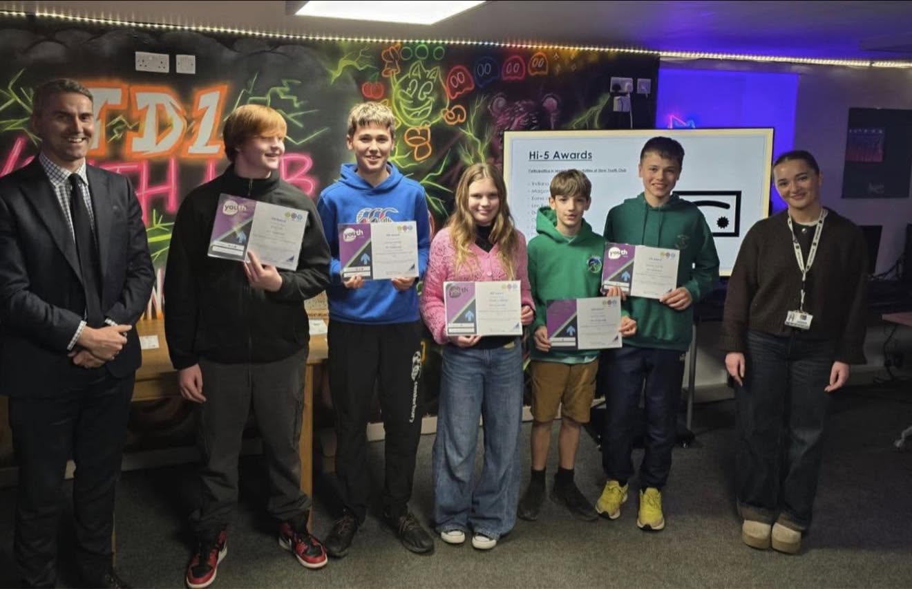 Young people celebrating their achievements with certificates