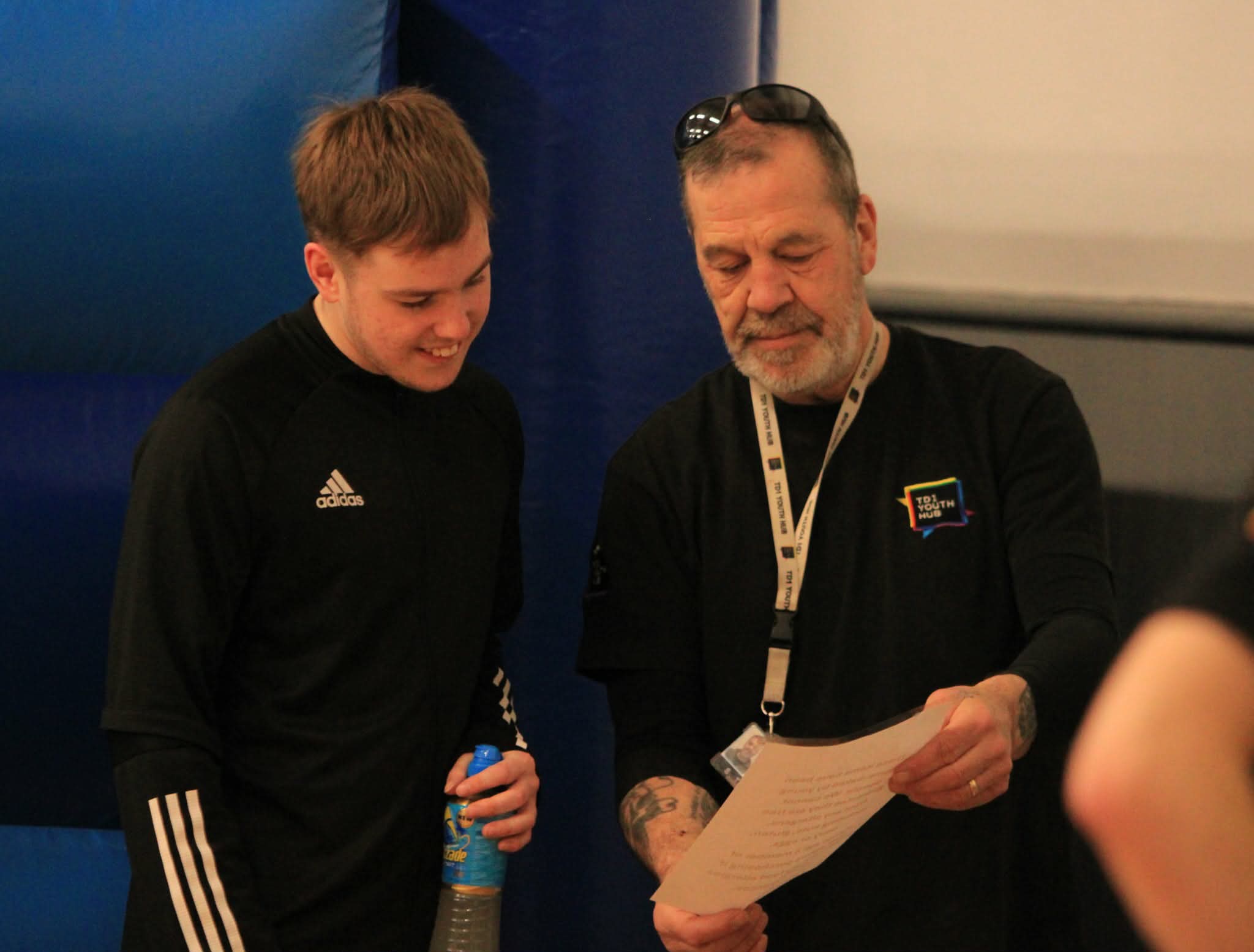 A young person and a TD1 worker looking through paperwork together