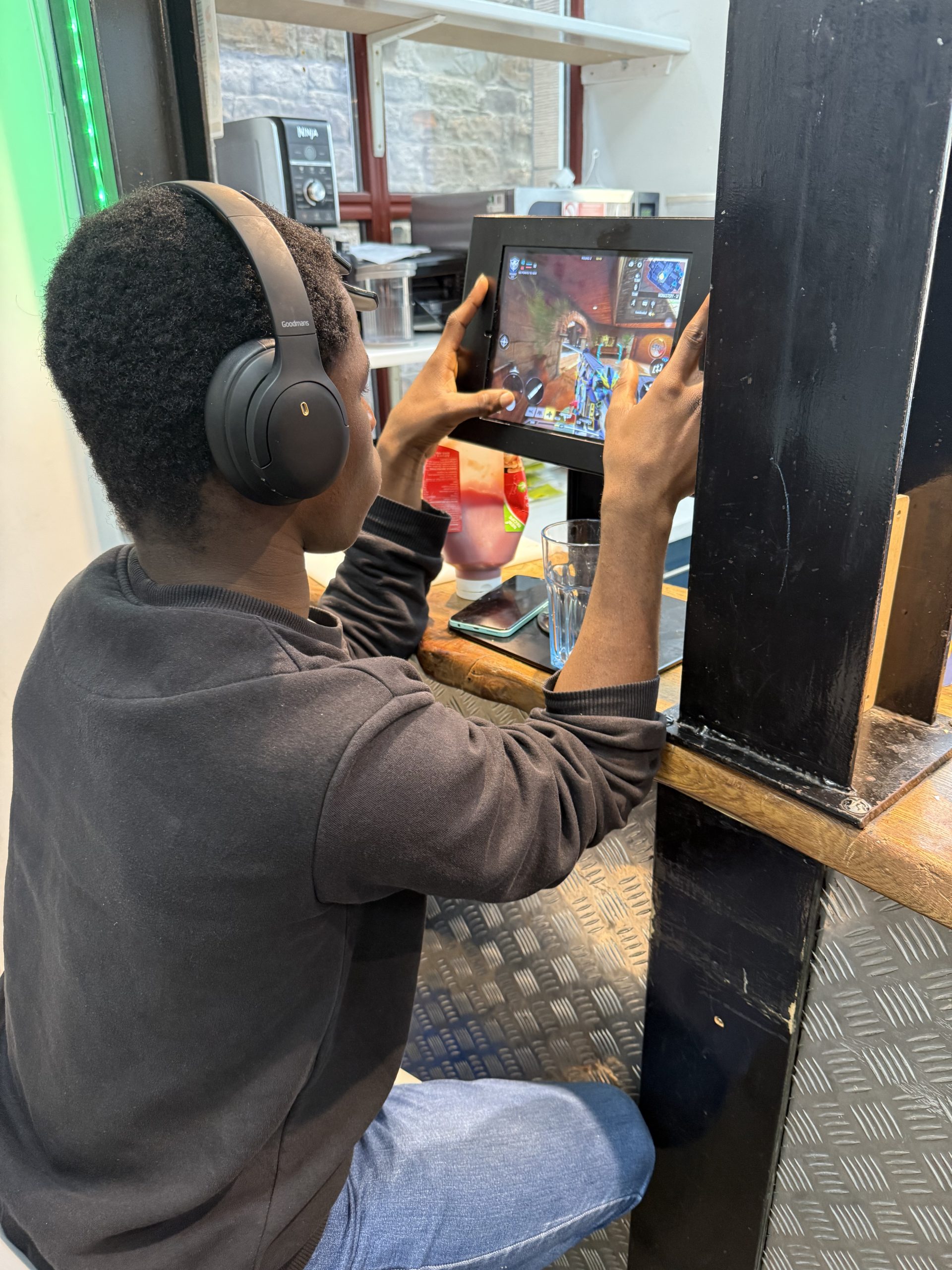 A young person playing an arcade game