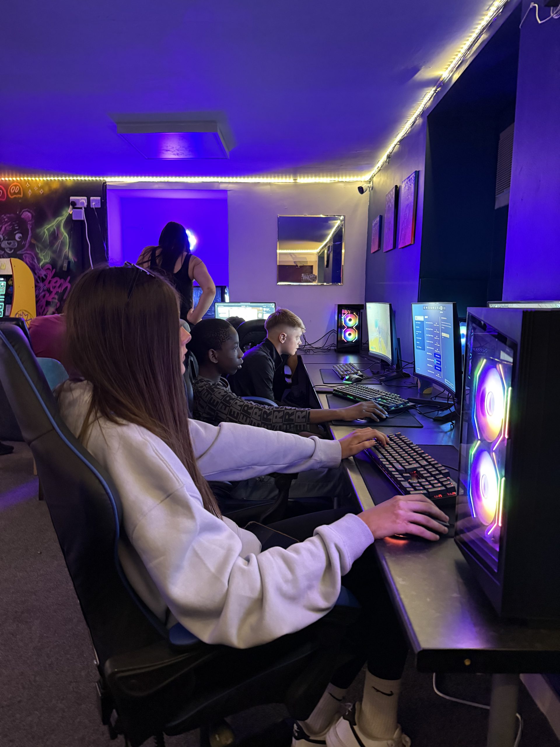 Young people playing computer games together at the hub